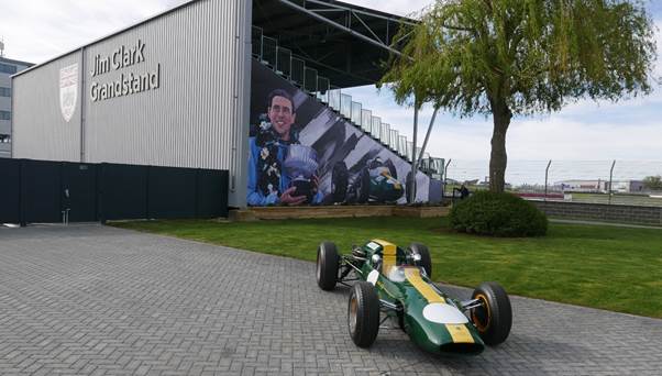 The renamed Jim Clark Grandstand beside the BRDC clubhouse and the Lotus 32B raced by Clark. (Photo Gauld)